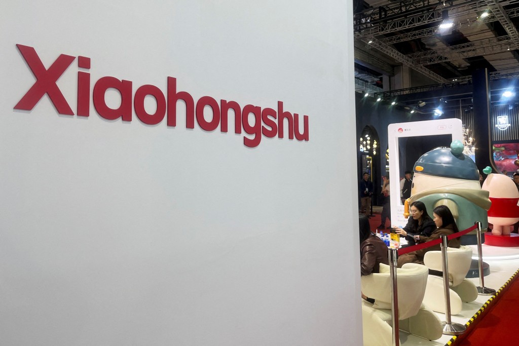 FILE PHOTO: People sit at the booth for Xiaohongshu app at the China International Import Expo (CIIE) in Shanghai, China November 6, 2024. REUTERS/Casey Hall/File Photo