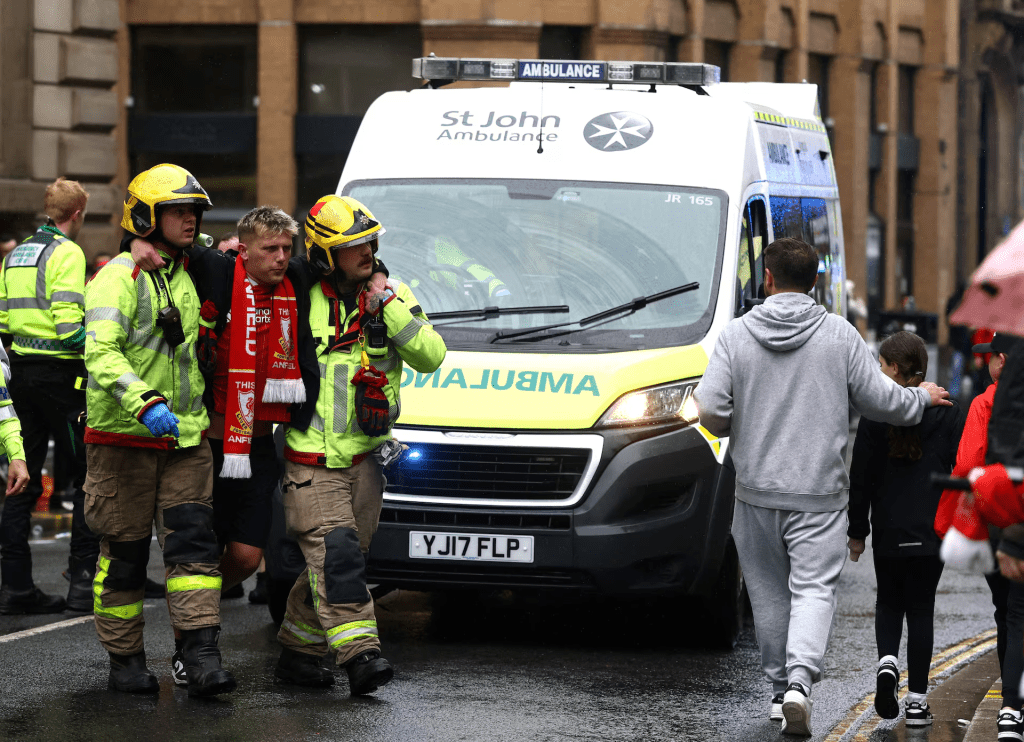 A fan is taken away by emergency services at an incident involving a car and supporters during the Victory parade in Liverpool, Britain, May 26, 2025. Action Images via Reuters/Lee Smith