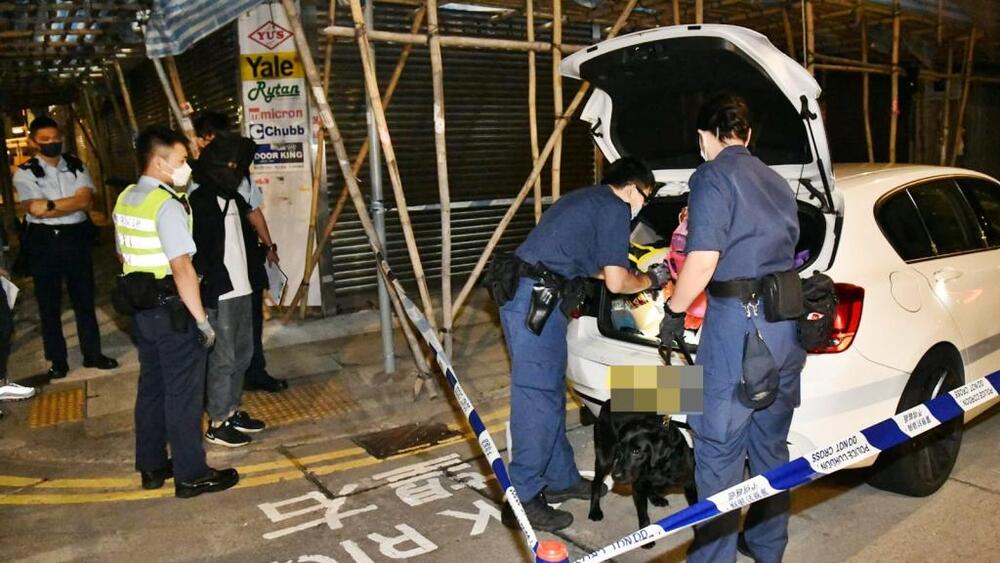 Police intercept the white BMW in Yau Ma Tei on Friday morning. 