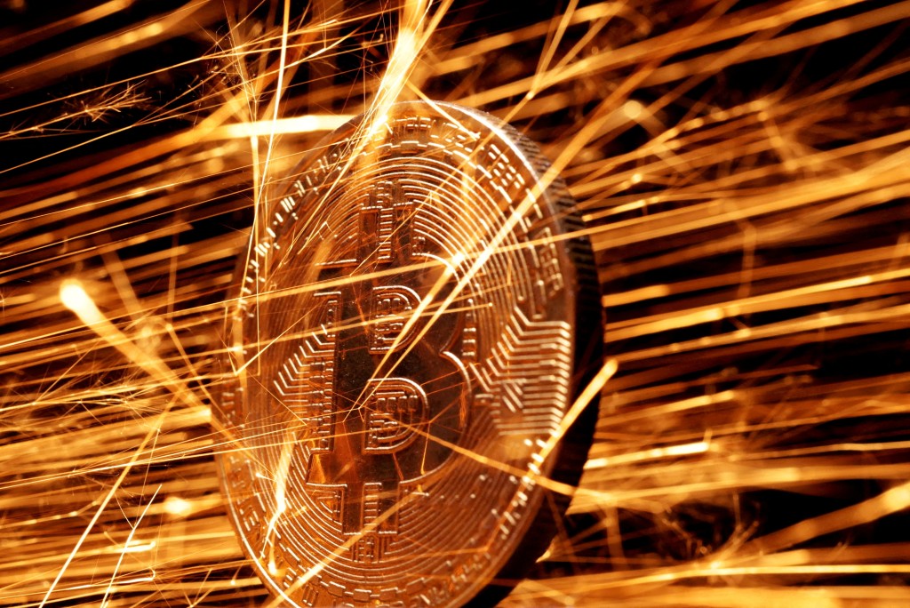 Sparks strike representation of cryptocurrency Bitcoin in this illustration taken November 24, 2024. REUTERS