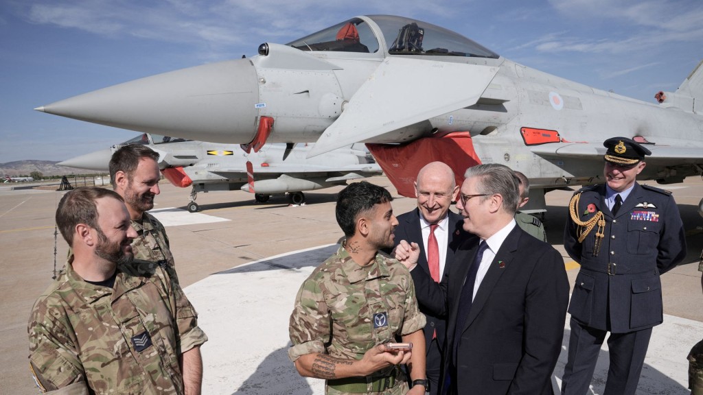 British Prime Minister Keir Starmer speak with British armed forces personnel in front of a UK Typhoon fighter jet. Reuters