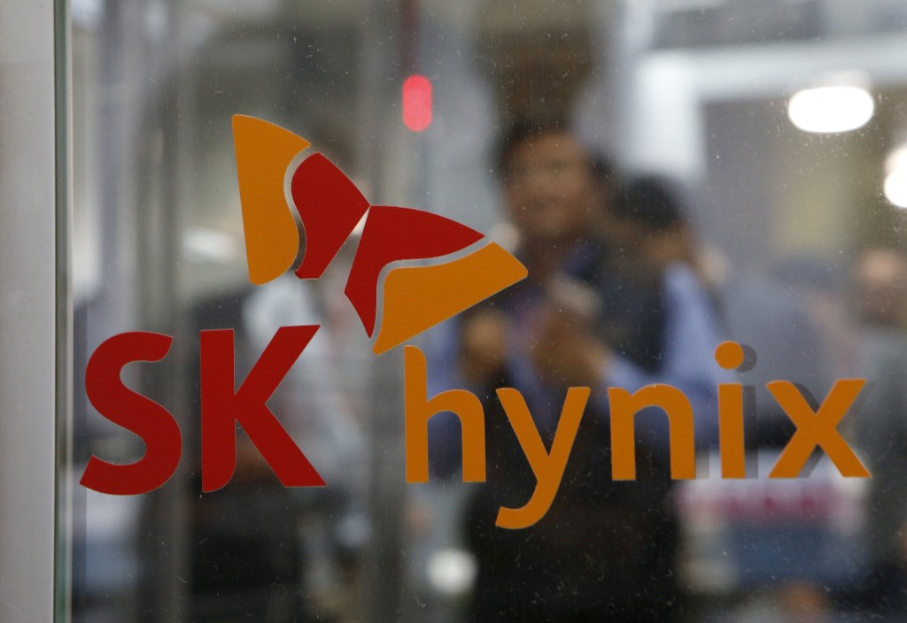 An employee walks past the logo of SK Hynix at its headquarters in Seongnam, South Korea, April 25, 2016. REUTERS