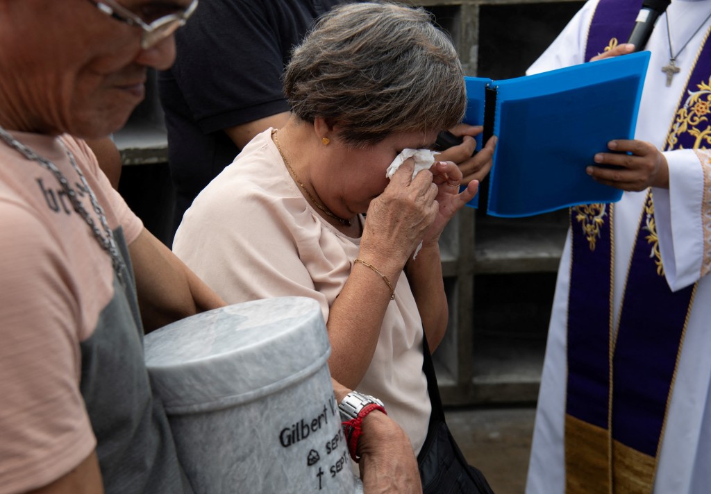 Photo by TED ALJIBE / AFP  A relative of one of the victims of extrajudicial killings of former Philippine president Rodrigo Duterte's drug war cries next to the urn of her son during the inurnment rites at the "Dambana ng Paghilom" (Shrine of Healing) at a cemetery in Caloocan city, suburban Manila on February 20, 2026.
