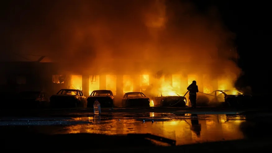 A rescue worker puts out a fire of cars destroyed by a Russian drone strike in Zaporizhzhia, Ukraine, on Wednesday, June 18, 2025. (AP Photo/Kateryna Klochko)