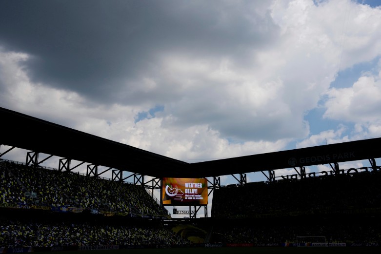 Bad weather interrupts the game between Boca Juniors and Auckland. (Associated Press)