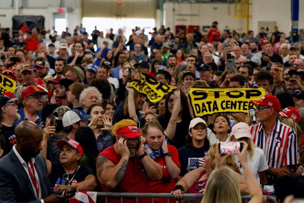 Protestors hold up 'Stop data centers' signs, on the day of U.S. President Donald Trump's speech at the General Motors Proving Ground, in Milford, Michigan, U.S. July 27, 2026. REUTERS/Carlos Osorio/File Photo
