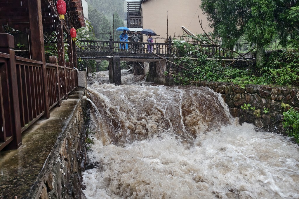 Officials help evacuate local residents in Lin'an district in Hangzhou, eastern China's Zhejiang province. (AFP)