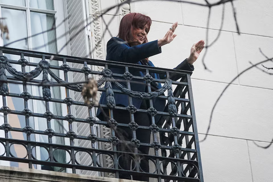 Former Argentinian President Cristina Fernandez de Kirchner gestures from the balcony of her home after Argentina's Supreme Court upheld her guilty verdict for defrauding the state, in Buenos Aires, Argentina, June 13, 2025. REUTERS/Mariana Nedelcu/File Photo