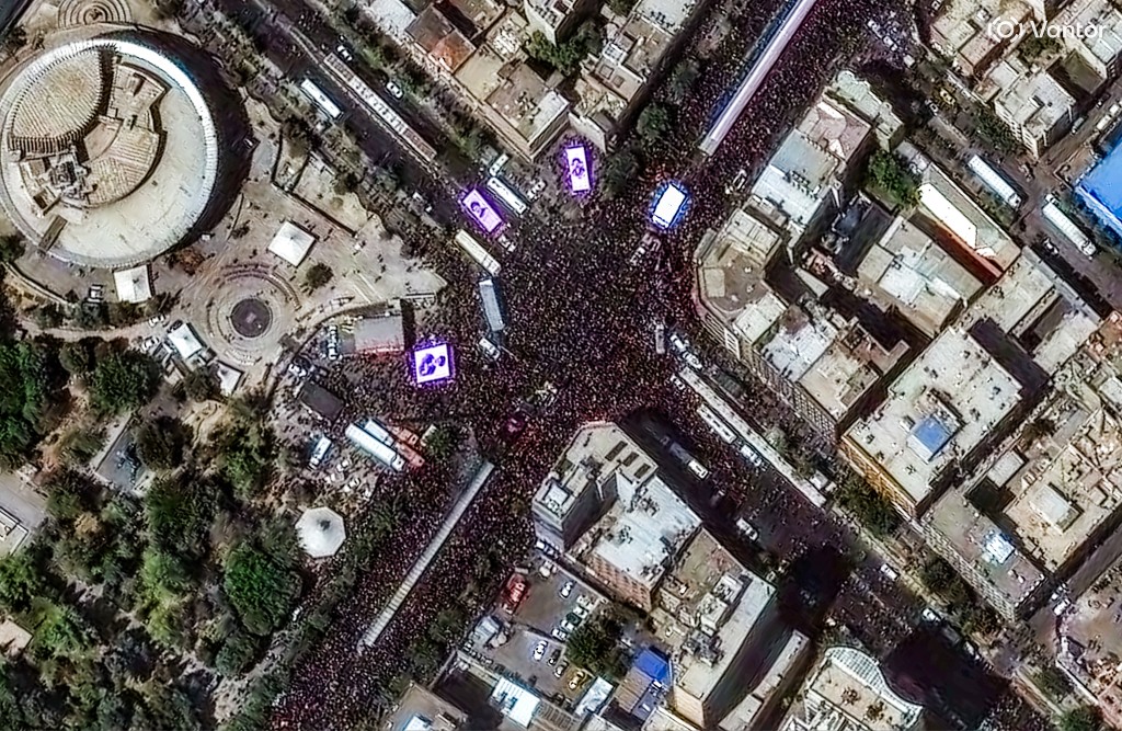 Photo by - / SATELLITE IMAGE ©2026 VANTOR / AFP  This handout satellite image released by Vantor shows large crowds of mourners congregating at Enghelab Square in Tehran on July 6, 2026, during the funeral procession for Iran's slain supreme leader Ali Khamenei.