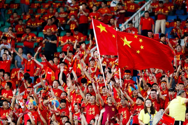 Chinese fans cheer for their soccer team during a match in Wuhan, Hubei province, August 31, 2017. REUTERS/Stringer/File Photo