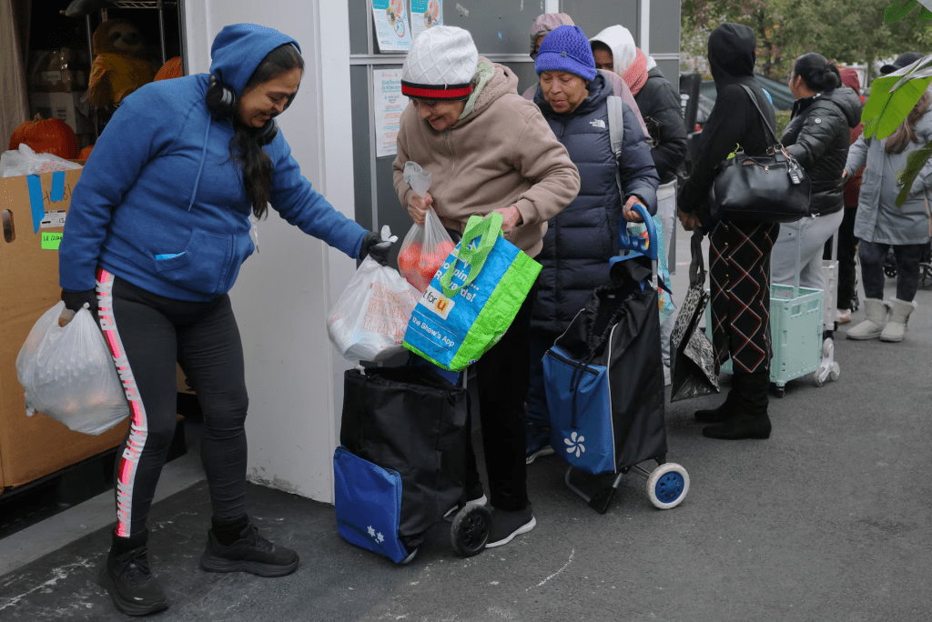 Workers distribute groceries at La Colaborativa’s food pantry in Chelsea, Massachusetts, U.S., October 29, 2025. REUTERS/Brian Snyder