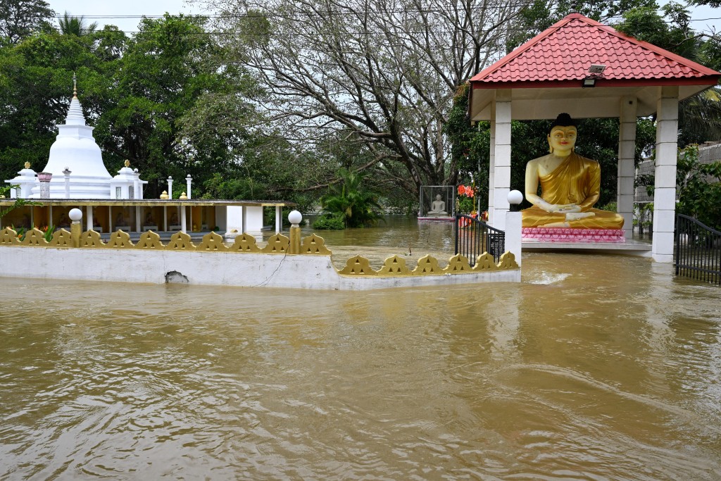 Photo by ISHARA S. KODIKARA / AFP  Floodwaters surround a Buddhist temple in Wellampitiya, on the outskirts of Colombo, on December 1, 2025.
