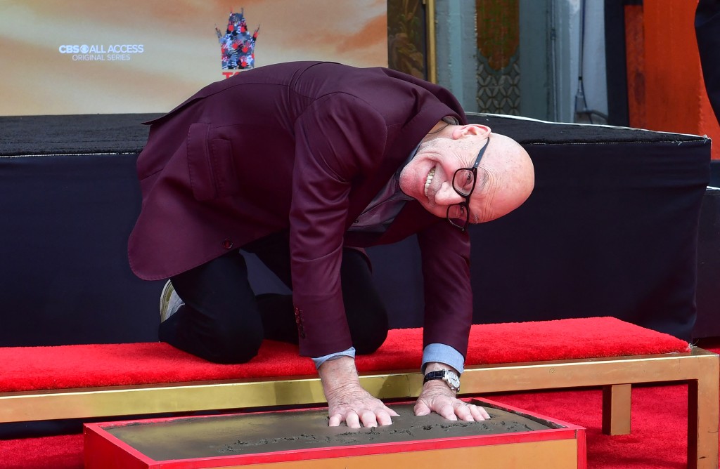 Photo by FREDERIC J. BROWN / AFP  British actor Sir Patrick Stewart poses as he places hands in the block of cement during his Hand and Footprints ceremony at the TCL Chinese Theater in Hollywood, California on January 13, 2020.