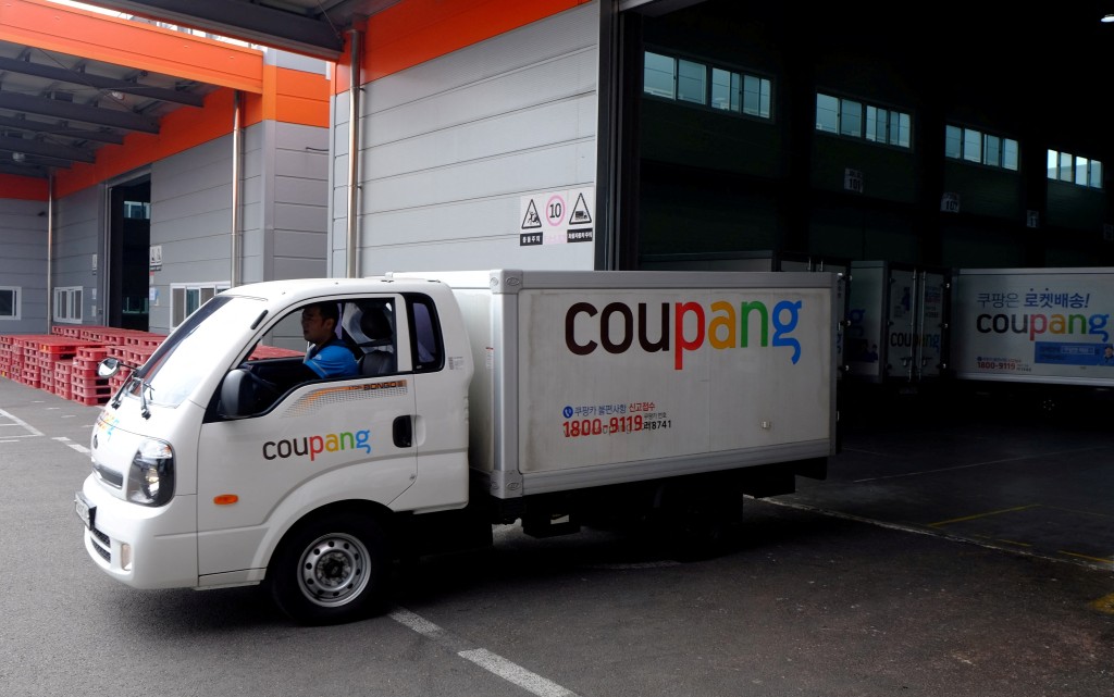 Delivery trucks for e-commerce retailer Coupang leave a distribution centre in Seoul, South Korea. (File Photo)
