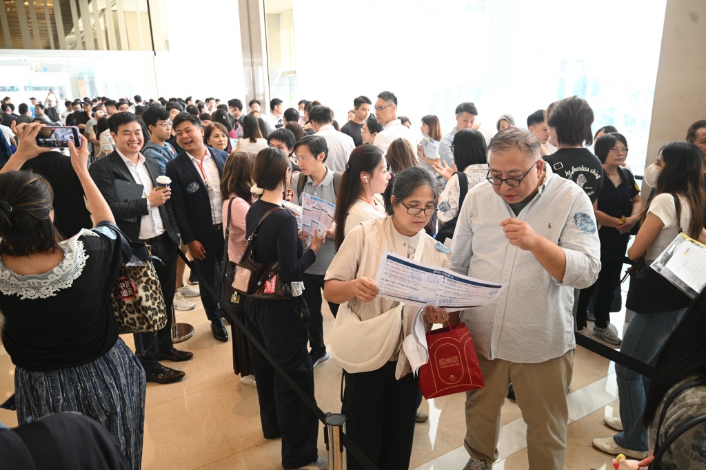 People wait in queue for The Atlas I's first-round sales.