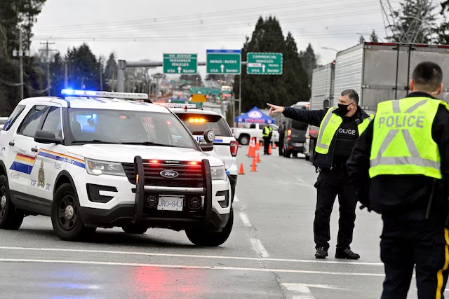 File photo - RCMP officers are seen at a checkpoint in British Columbia, Canada, February 19, 2022. REUTERS/Jennifer Gauthier