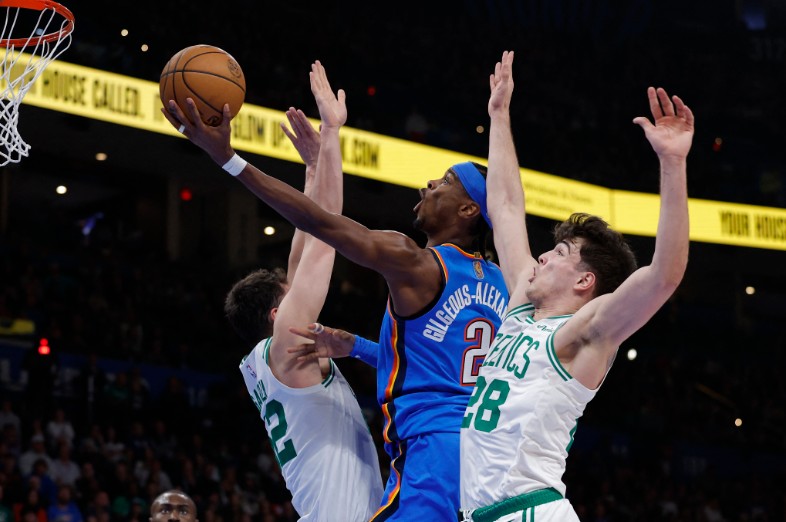 Shai Gilgeous-Alexander goes up for a basket between Boston Celtics center Luka Garza, left, and guard Hugo Gonzalez. REUTERS 