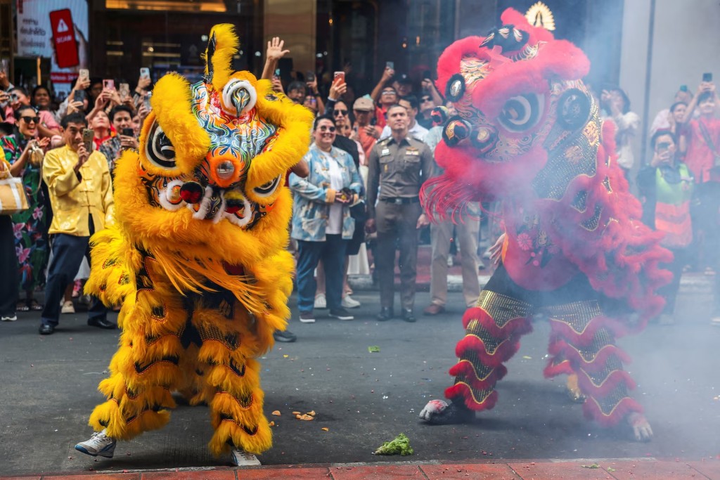 Lion dancers perform on the eve of Lunar New Year in Chinatown, Bangkok, Thailand, February 16. REUTERS/Chalinee Thirasupa
