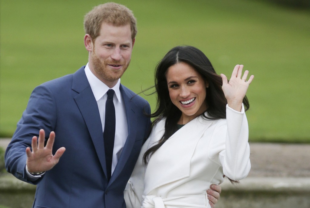 Photo by DANIEL LEAL / AFP. Britain's Prince Harry and his fiancée US actress Meghan Markle pose for a photograph in the Sunken Garden at Kensington Palace in west London on November 27, 2017, following the announcement of their engagement.