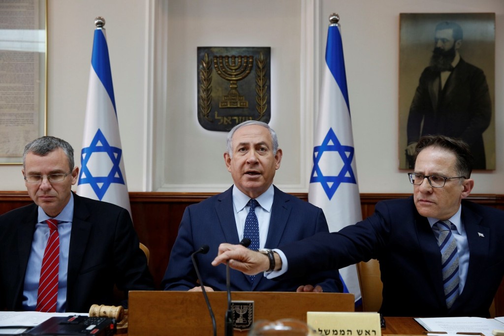 Israeli Prime Minister Benjamin Netanyahu (C) sits next to Cabinet Secretary Tzachi Braverman (R) and Israeli Minister for Jerusalem Affairs Zeev Elkin (L) at the start of the weekly cabinet meeting at the Prime Minister's office in Jerusalem January 7, 2018. REUTERS/Abir Sultan/Pool