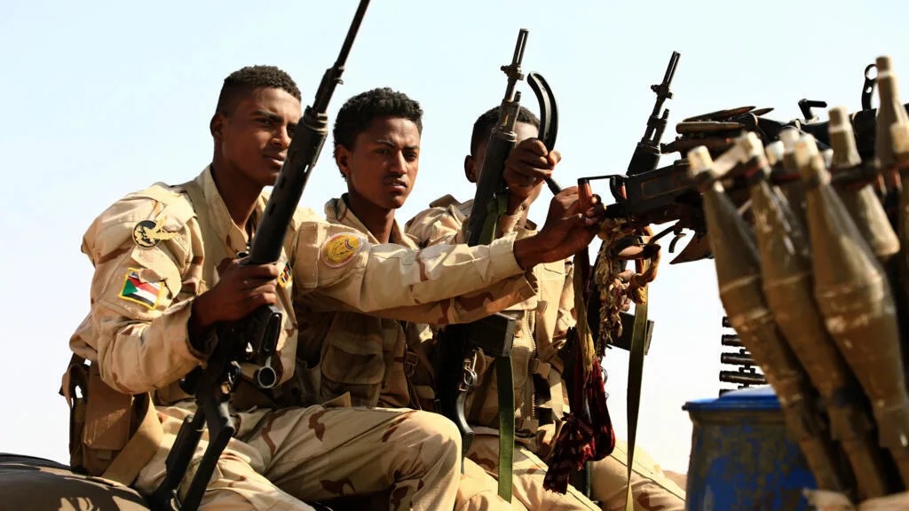 In this file photo, Sudanese soldiers from the Rapid Support Forces unit patrol during a rally for Dagalo, in Garawee town, north of Sudan on June 15, 2019.