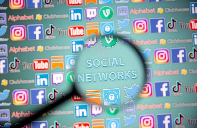Social network words and social media logos are seen through magnifier displayed in this illustration taken, May 25, 2021. Picture taken May 25, 2021. REUTERS/Dado Ruvic/Illustration 