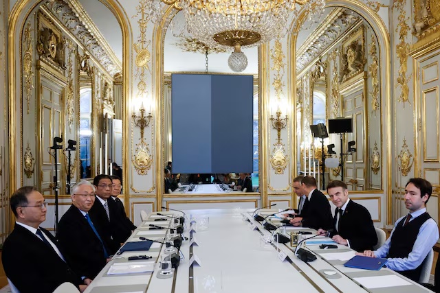 French President Emmanuel Macron and Chinese Vice Premier Zhang Guoqing sit during their meeting at Elysee Palace in Paris, France, February 10 2025, on the sidelines of the Artificial Intelligence Action Summit. Mohammed Badra/Pool via REUTERS