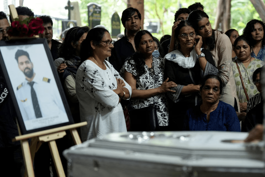 Friends and family members mourn near the coffin of Co-Pilot Clive Kunder, who died after an AIR India Boeing 787-8 Dreamliner plane crashed during take-off from an airport in Ahmedabad, in Mumbai, India June 19, 2025. REUTERS/Hemanshi Kamani/File Photo