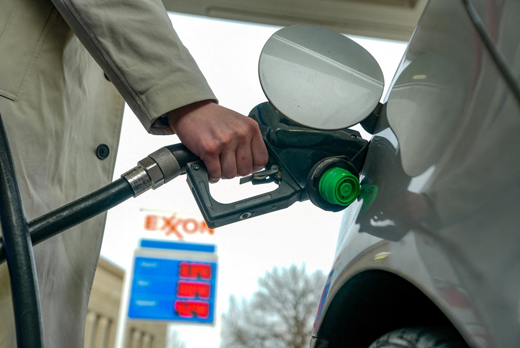 FILE PHOTO: A man pumps gas at an Exxon station as the price of oil and gas has surged amid the U.S.-Israeli conflict with Iran, in Washington, D.C., U.S., March 5, 2026. REUTERS/Ken Cedeno/File Photo