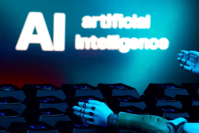 A message reading "AI artificial intelligence", a keyboard, and robot hands are seen in this illustration taken January 27, 2025. REUTERS/Dado Ruvic/Illustration/File Photo 