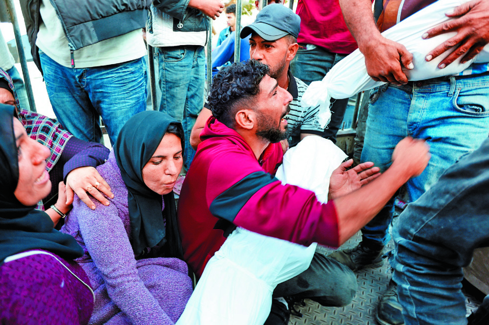 Palestinians mourn those killed in an airstrike on a hospital in central Gaza Strip. REUTERS Palestinians mourn those killed in an airstrike on a hospital in central Gaza Strip. REUTERS