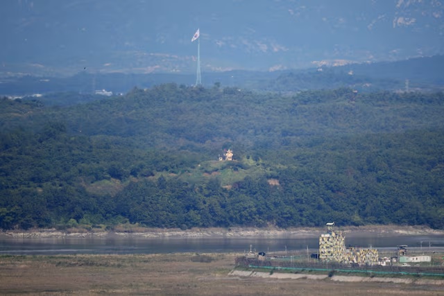 South and North Korean guard posts face each other as a South Korean national flag flutters in this picture taken from the Unification Observation Platform, near the demilitarized zone which separates the two Koreas in Paju, South Korea, October 6, 2022. REUTERS/Kim Hong-Ji