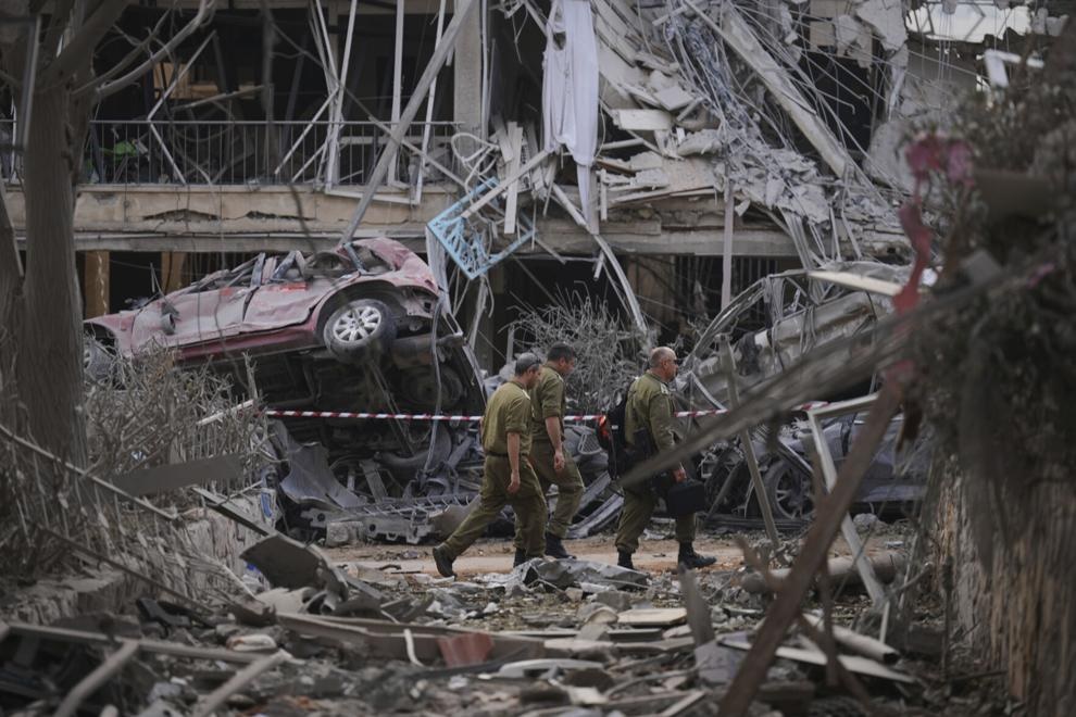 Israeli security forces inspect destroyed residential buildings that were hit by a missile fired from Iran, in Ramat Gan, near Tel Aviv, Israel, on Saturday, June 14, 2025. (AP Photo/Ariel Schalit)