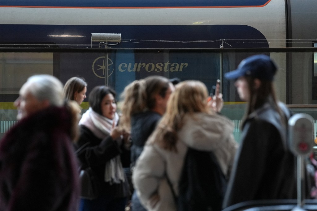 Passengers stand near a Eurostar train carriage, after a Eurostar spokesperson said they were suspending its cross-Channel train services to and from London until further notice following a power supply problem in the Channel Tunnel that links Britain and France, at St. Pancras International station in London, Britain, December 30, 2025. (Reuters)