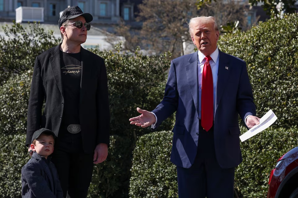 U.S. President Donald Trump talks to the media, next to Tesla CEO Elon Musk with his son X Æ A-12, at the White House in Washington, D.C., U.S., March 11, 2025. REUTERS/Kevin Lamarque U.S. President Donald Trump talks to the media, next to Tesla CEO Elon Musk with his son X Æ A-12, at the White House in Washington, D.C., U.S., March 11, 2025. REUTERS/Kevin Lamarque