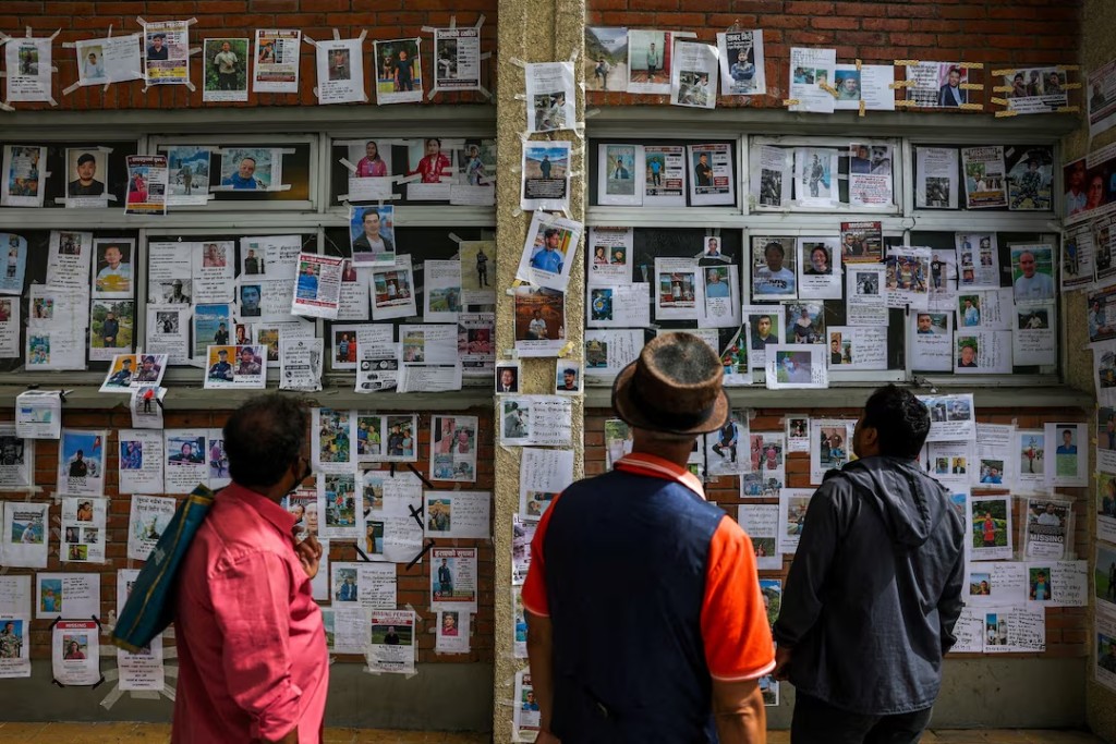 People look at photographs of missing people on a wall outside Tribhuvan University Teaching Hospital following the deadly flash floods and mudslide, reacts outside Tribhuvan University Teaching Hospital, in Kathmandu, Nepal, September 2, 2026. REUTERS/Athit Perawongmetha /File Photo