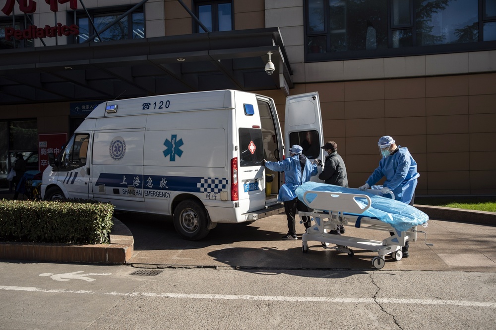 Health workers in protective gear transport a bed outside the emergency room of a hospital in Shanghai last year. (Bloomberg) Health workers in protective gear transport a bed outside the emergency room of a hospital in Shanghai last year. (Bloomberg)
