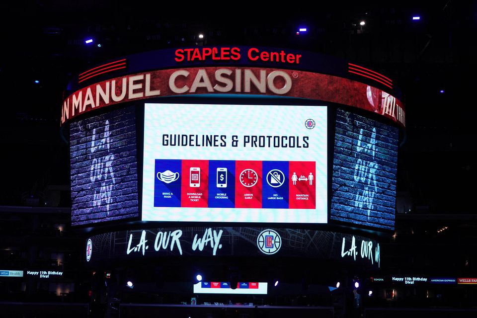 Covid-19 health and hygiene protocols are displayed on the Staples Center during the NBA game between the LA Clippers and the Los Angeles Lakers. (Reuters) Covid-19 health and hygiene protocols are displayed on the Staples Center during the NBA game between the LA Clippers and the Los Angeles Lakers. (Reuters)