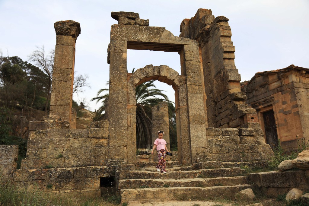 Photo by ABDULLAH DOMA / AFP  A girl visits the Sanctuary of Apollo at Cyrene near the ancient historical town of Shahat in the northeastern Mediterranean coast of Libya on May 17, 2026.