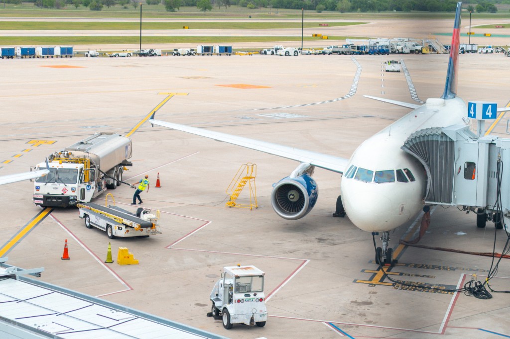 A technician prepares to refuel a Delta Airlines aircraft at the Austin-Bergrstrom International Airport on April 10, 2026 in Austin, Texas. Airlines have begun cutting flights and increasing airfare as jet fuel costs continue rising due to the ongoing conflict in the Middle East. Brandon Bell/Getty Images/AFP