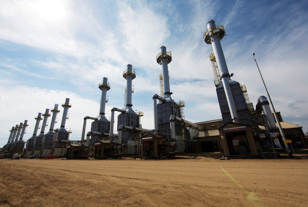 Rows of steam generators line a road at the Cenovus Energy Christina Lake Steam-Assisted Gravity Drainage (SAGD) project 120 km (74 miles) south of Fort McMurray, Alberta, Canada, August 15, 2013. REUTERS/Todd Korol/File Photo