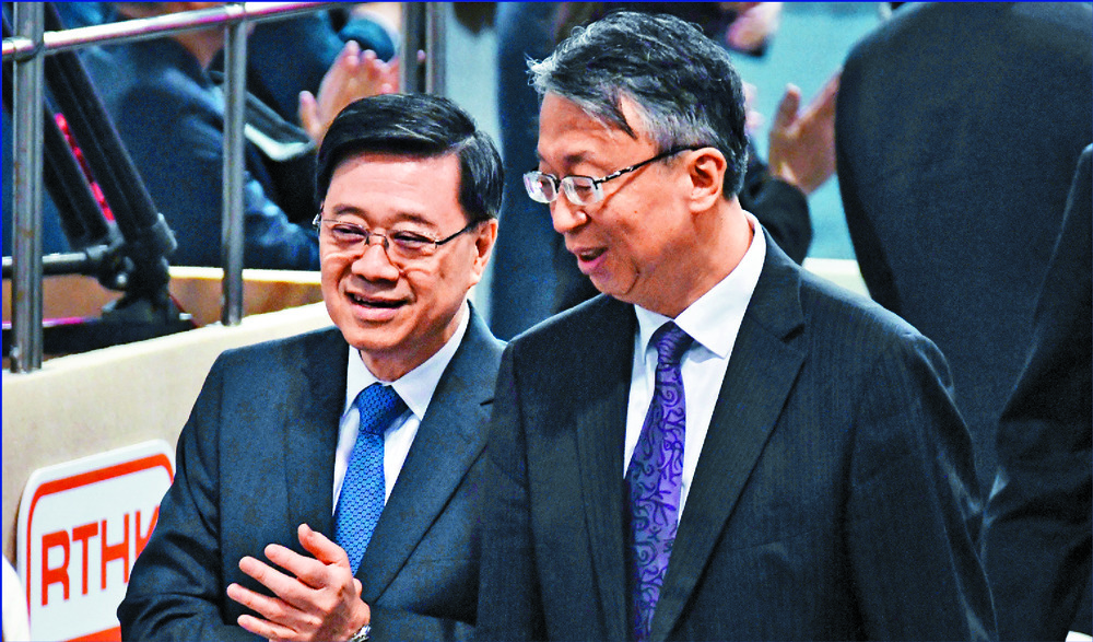 The city is not just a bystander, says John Lee, left, seen with Shen Chunyao at the seminar. Right: Wang Wentao. SING TAO The city is not just a bystander, says John Lee, left, seen with Shen Chunyao at the seminar. Right: Wang Wentao. SING TAO