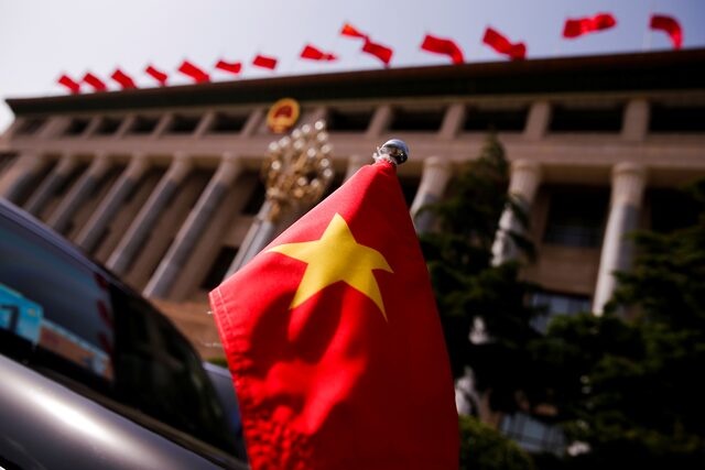The Vietnamese national flag flies on a diplomatic car outside the Great Hall of the People in Beijing, China, May 12, 2017. REUTERS/Thomas Peter/File Photo