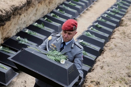 With the remains of fallen German soldiers of WWII to the grave during a funeral service at a memorial site for fallen soldiers in Halbe, Germany, Wednesday, April 30, 2025. (AP Photo/Ebrahim Noroozi)[ASSOCIATED PRESS/Ebrahim Noroozi]
