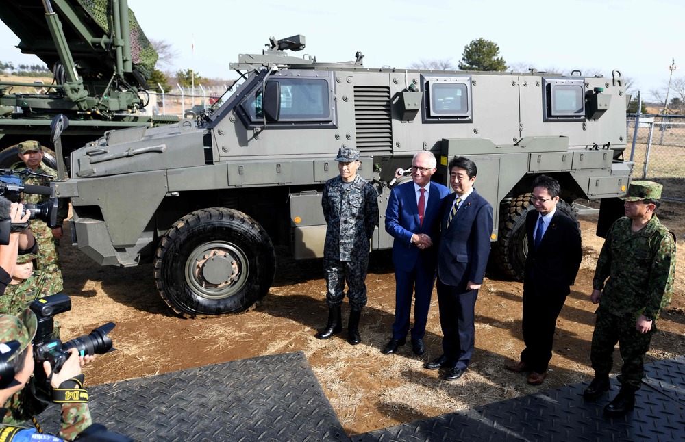 Former Australian Prime Minister Malcolm Turnbull (2nd L) shakes hands with former Japanese Prime Minister Shinzo Abe (C) in front of an Australian-made Bushmaster protected mobility vehicle, the same vehicle Zelensky has requested. (AFP) Former Australian Prime Minister Malcolm Turnbull (2nd L) shakes hands with former Japanese Prime Minister Shinzo Abe (C) in front of an Australian-made Bushmaster protected mobility vehicle, the same vehicle Zelensky has requested. (AFP)