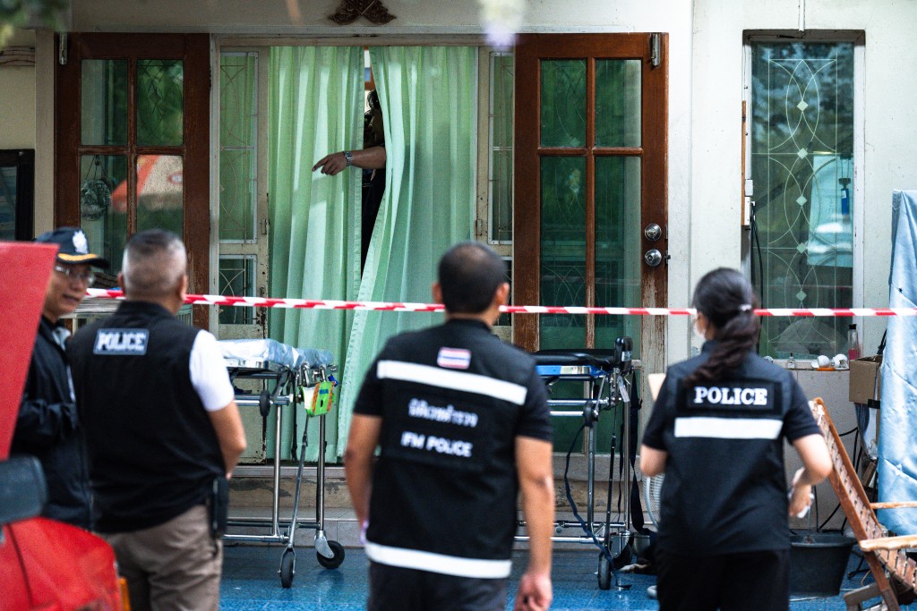 Police gather outside the house where a teenage suspect is suspected of killing his grandparents before carrying out a school shooting in Nonthaburi province, north of Thailand's capital Bangkok, on August 7, 2026. (AFP)