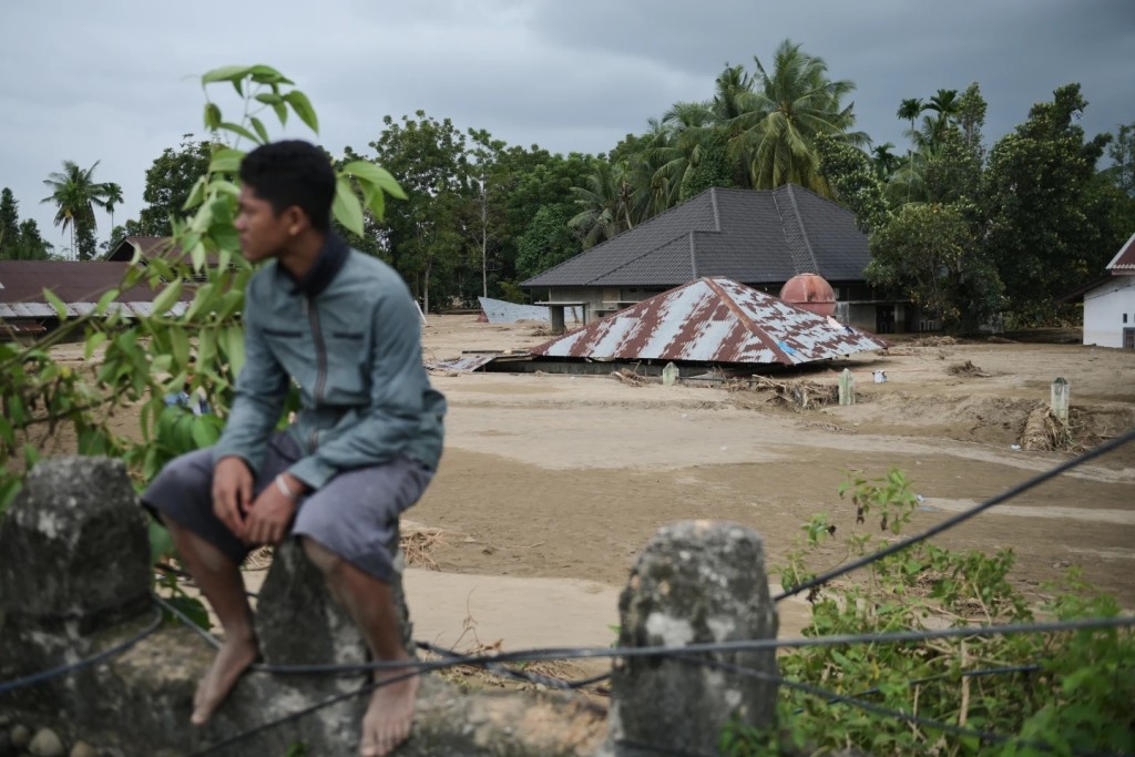 A house is seen buried in the mud at a village affected by flash flood in Pidie Jaya, Aceh province, Indonesia, Tuesday, Dec. 2, 2025. (AP Photo/Reza Saifullah)