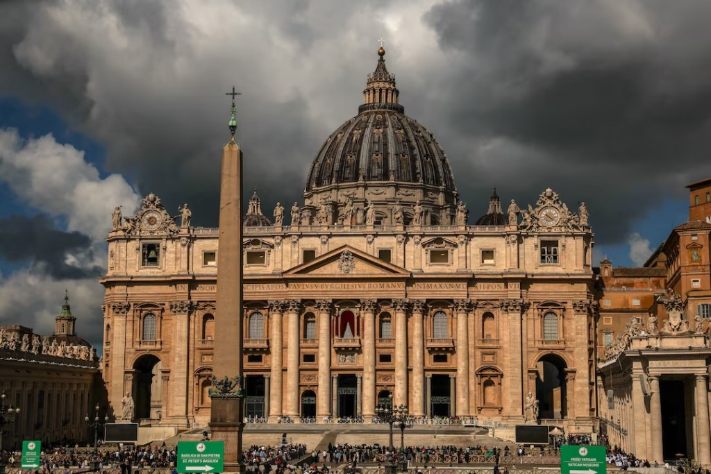 People gather in front of St. Peter's Square and St. Peter's Basilica, on the second day of the conclave to elect the new pope, as seen from Rome, Italy May 8, 2025. (Reuters)