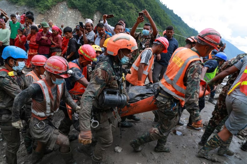 Members of the Nepal Army search and rescue team carry a survivor they rescued alive after he had been trapped inside a tunnel at the Trishuli 3A Hydropower Project following devastating floods and mudslides that struck the Bhotekoshi River in Rasuwa, Nepal, September 4, 2026. Nepal Army/Handout via REUTERS
