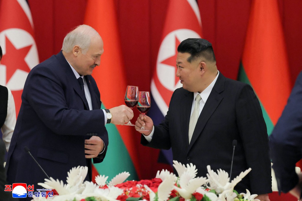 This picture taken on March 26, 2026 and released by North Korea's official Korean Central News Agency (KCNA) on March 27, 2026 shows North Korean leader Kim Jong Un (R) and Belarus' President Alexander Lukashenko (L) toasting at a banquet in Pyongyang. (Photo by KCNA VIA KNS / AFP)